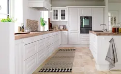 Marble apron and wooden countertop in the kitchen photo