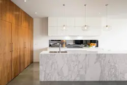 Marble apron and wooden countertop in the kitchen photo