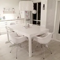 White table and black chairs for the kitchen photo