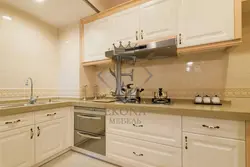 Cream kitchen with wooden countertop and apron photo