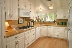 Cream Kitchen With Wooden Countertop And Apron Photo