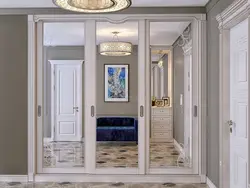 White wardrobe in the hallway with a mirror photo