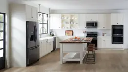 Black Refrigerator In A White Kitchen In The Interior Photo