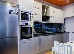 Photo of a kitchen with a pencil case for an oven and microwave
