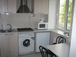 Photo of a kitchen in Khrushchev with a refrigerator and a washing machine photo