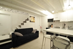 Black sofa in the kitchen interior