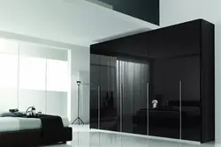 Black wardrobe in the bedroom interior