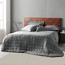 Gray bedspread in the bedroom interior