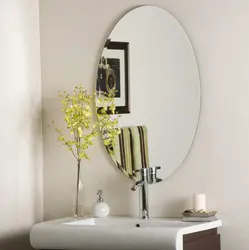 Oval mirror in the bathroom interior
