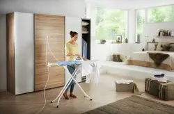 Ironing board in the bedroom interior