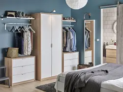Narrow wardrobe in the bedroom interior