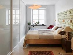 Narrow wardrobe in the bedroom interior