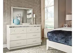 Gray chest of drawers in the bedroom interior