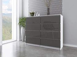 Gray chest of drawers in the bedroom interior