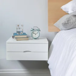 White nightstands in the bedroom interior
