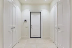 White entrance door in the hallway interior