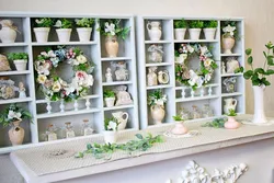 Shelf with flowers in the living room interior