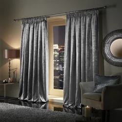 Velvet gray curtains in the living room interior