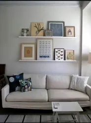 Paintings on a shelf in the living room interior