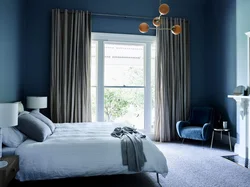 Gray-blue curtains in the bedroom interior