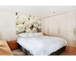 Bedroom interior with roses on wallpaper