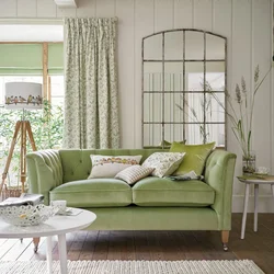 Green sofa in a beige living room interior