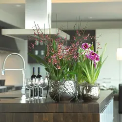 Vase with flowers in the kitchen interior