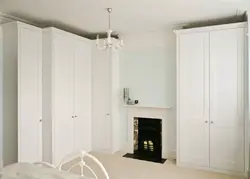 White corner wardrobe in the bedroom interior