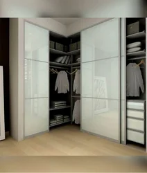 White corner wardrobe in the bedroom interior