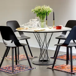 Table with black legs in the kitchen interior