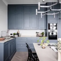 Gray kitchen with black handles in the interior