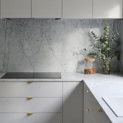 Gray kitchen in the interior with marble countertops