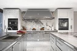 Gray kitchen in the interior with marble countertops