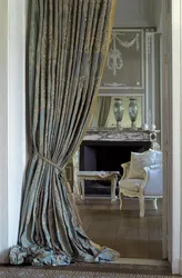 Marble curtains in the interior with tulle in the living room