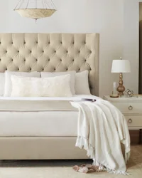 Beige Bed With A Soft Headboard In The Bedroom Interior