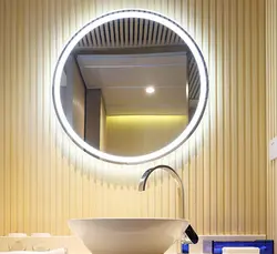 Round mirror with lighting in the bathroom in the interior