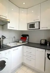 Corner kitchen design with refrigerator and microwave