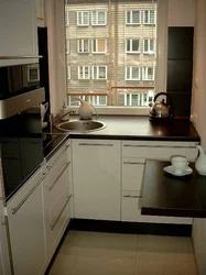 Дызайн кухні з халадзільнікам у куце ў акна