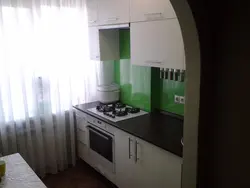 Kitchen design with a refrigerator by the window and a gas stove