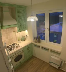 Kitchen Design With A Refrigerator By The Window And A Gas Stove