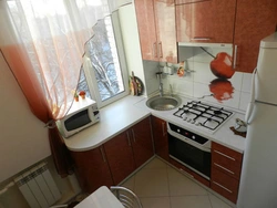 Kitchen Design With A Refrigerator By The Window And A Gas Stove