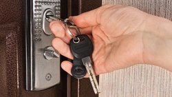 Photo of apartment door with keys