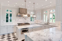 White kitchen design with marble countertops