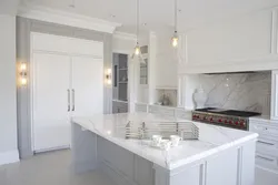 White kitchen design with marble countertops