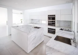 White kitchen design with marble countertops