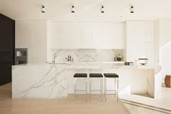 White kitchen design with marble countertops