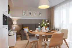 Дизайн кухни гостиной с диваном и столом