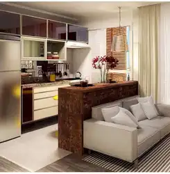Kitchen design in a one-room apartment with a sofa