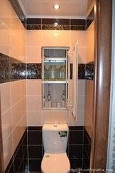 Design Of A Toilet In An Apartment With A Cabinet And Tiles