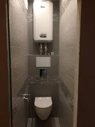Design of a toilet in an apartment with a cabinet and tiles